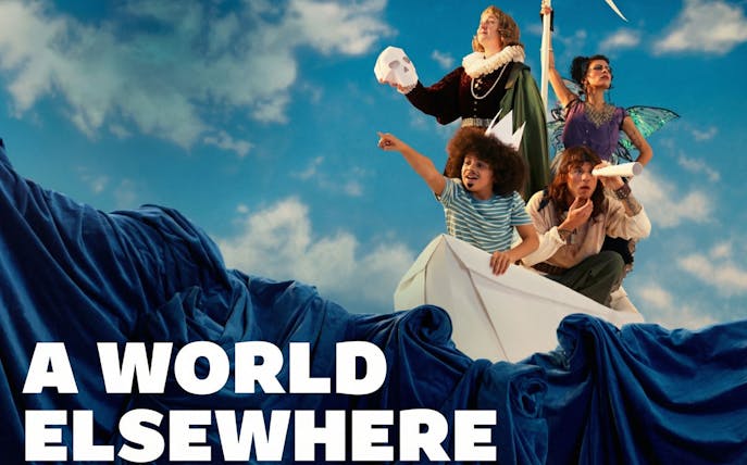 Group on paper boat with costumes, pointing and looking ahead, "A World Elsewhere Westend" theme.