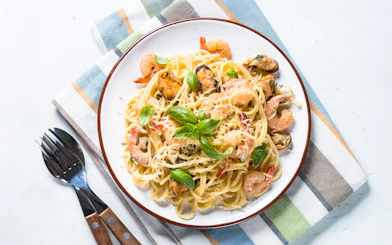 Seafood pasta with cream sauce served on Steamboat Natchez Evening Dinner Cruise.