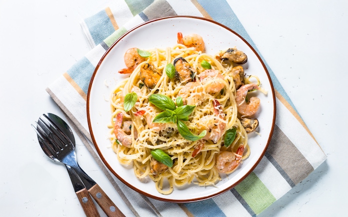 Seafood pasta with cream sauce served on Steamboat Natchez Evening Dinner Cruise.