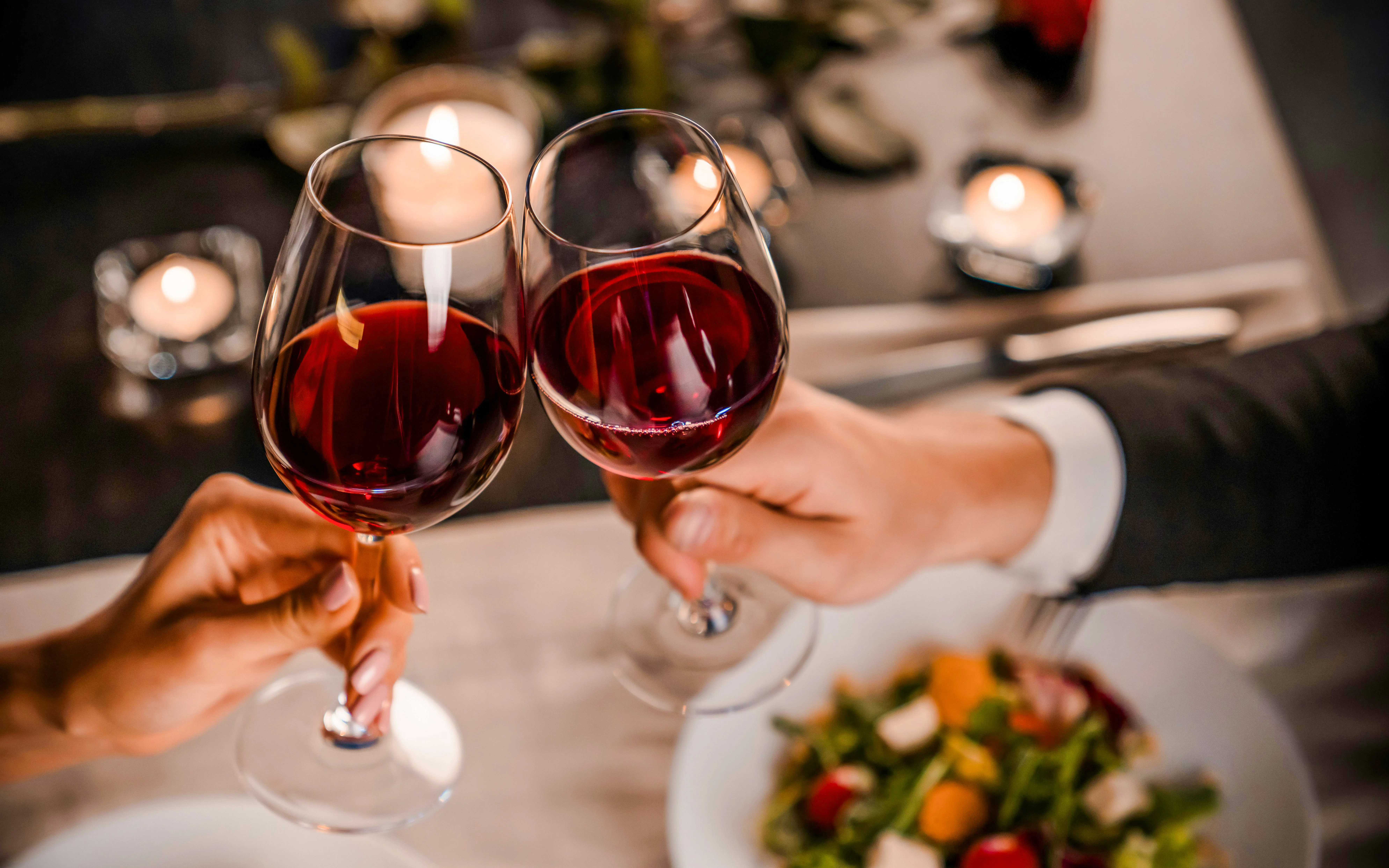 Toasting with red wine at a Paris cafe table.
