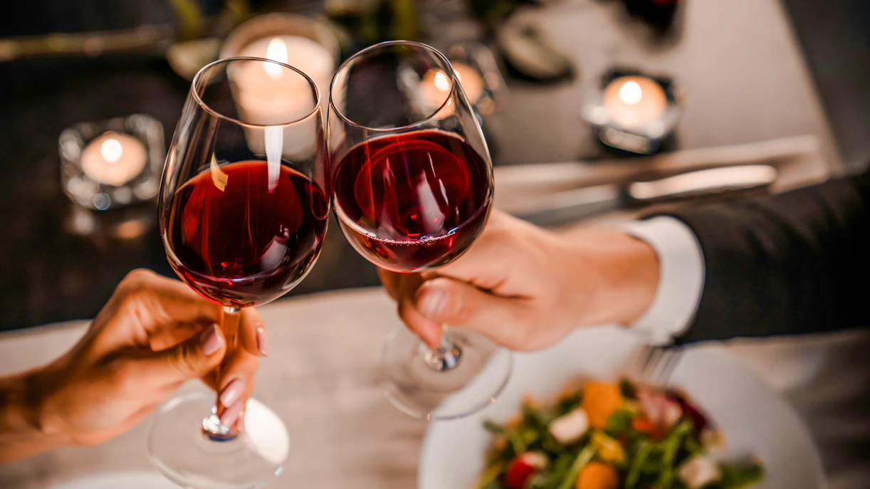 Toasting with red wine at a Paris cafe table.