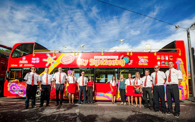 Guides and operators in front of Santa Cruz City Sightseeing bus.