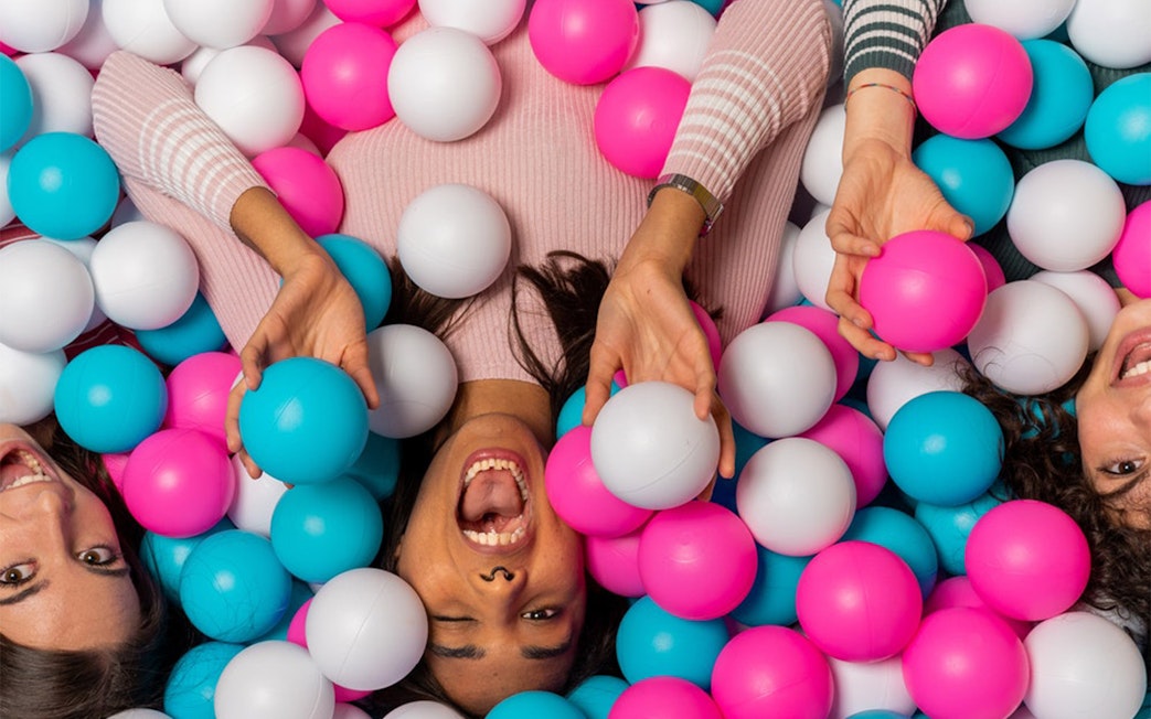 Visitors enjoying a colorful ball pit at Big Fun Museum, Barcelona.