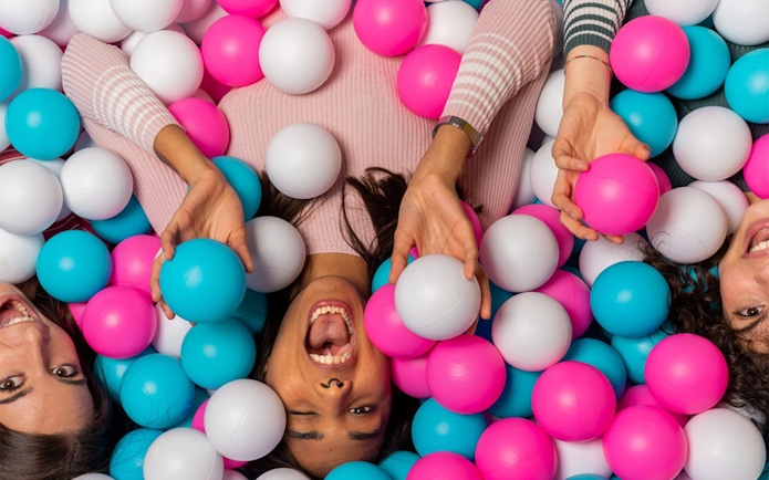 Visitors enjoying a colorful ball pit at Big Fun Museum, Barcelona.