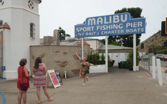 Malibu Sport Fishing Pier entrance with tourists, part of Santa Monica to Malibu tour.