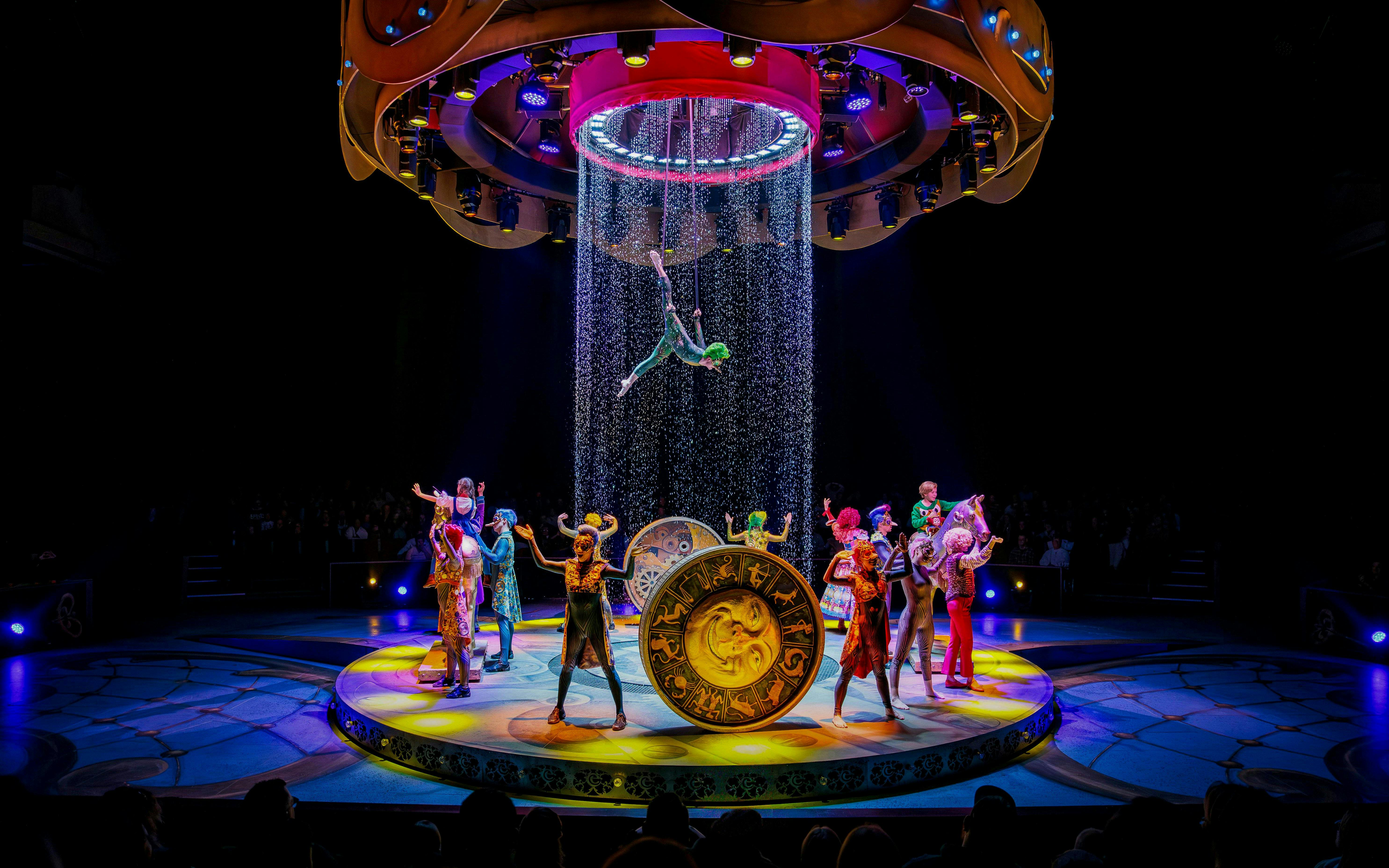 Performers on stage during CARO Theatre Show at Efteling Amsterdam with acrobat suspended above.