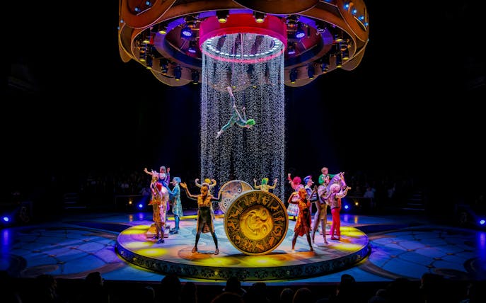 Performers on stage during CARO Theatre Show at Efteling Amsterdam with acrobat suspended above.