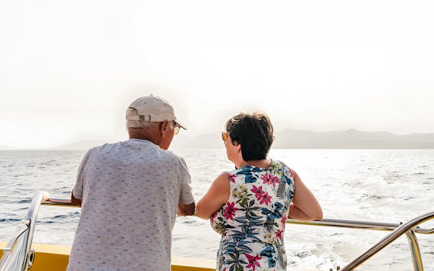 Tourists enjoying sunset views on a speedboat during a dolphin cruise.