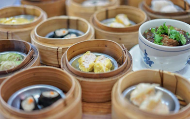 Dim sum baskets and a bowl of soup on a table during a Phuket guided tour.