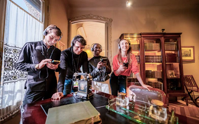 Visitors using audio guides at La Pedrera-Casa Milà in Barcelona.