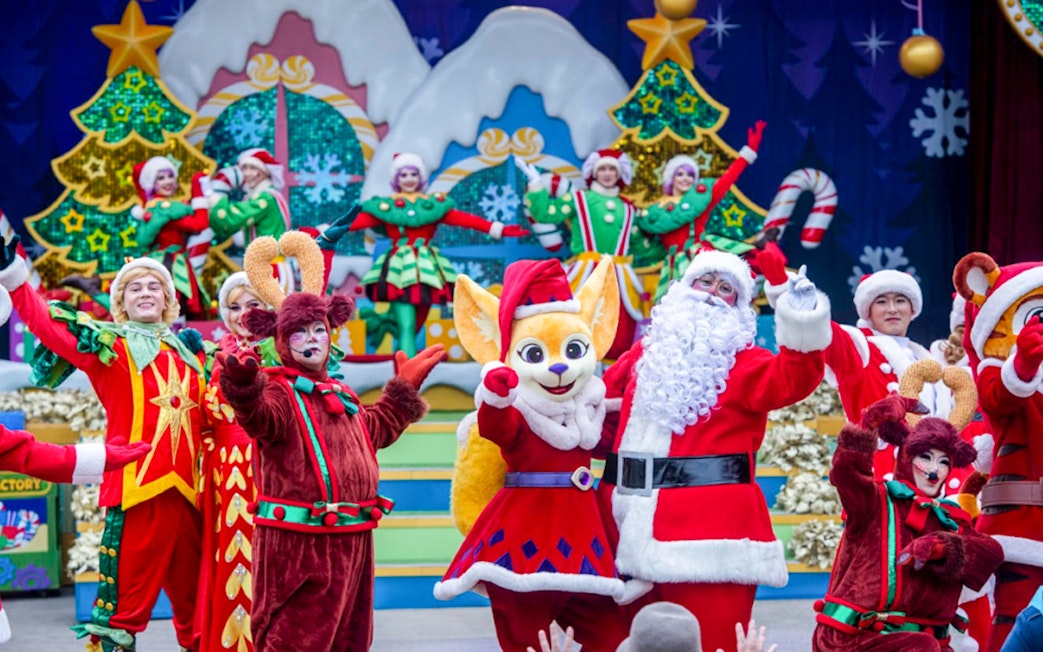 Everland Christmas performance with Santa and festive characters on stage.