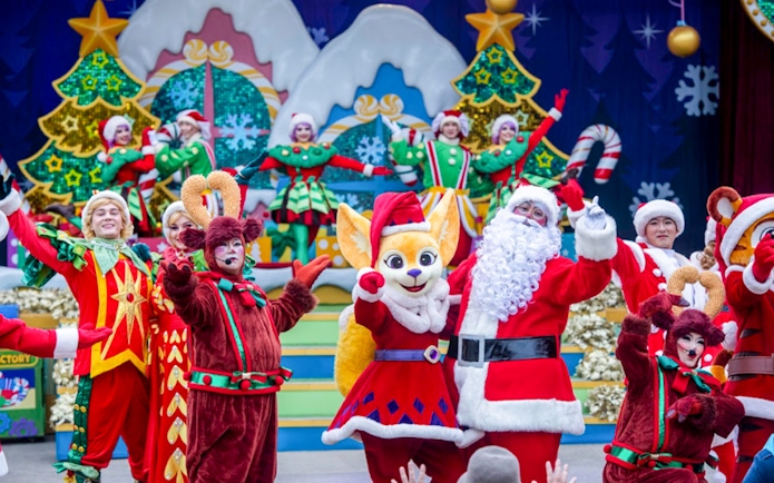 Everland Christmas performance with Santa and festive characters on stage.