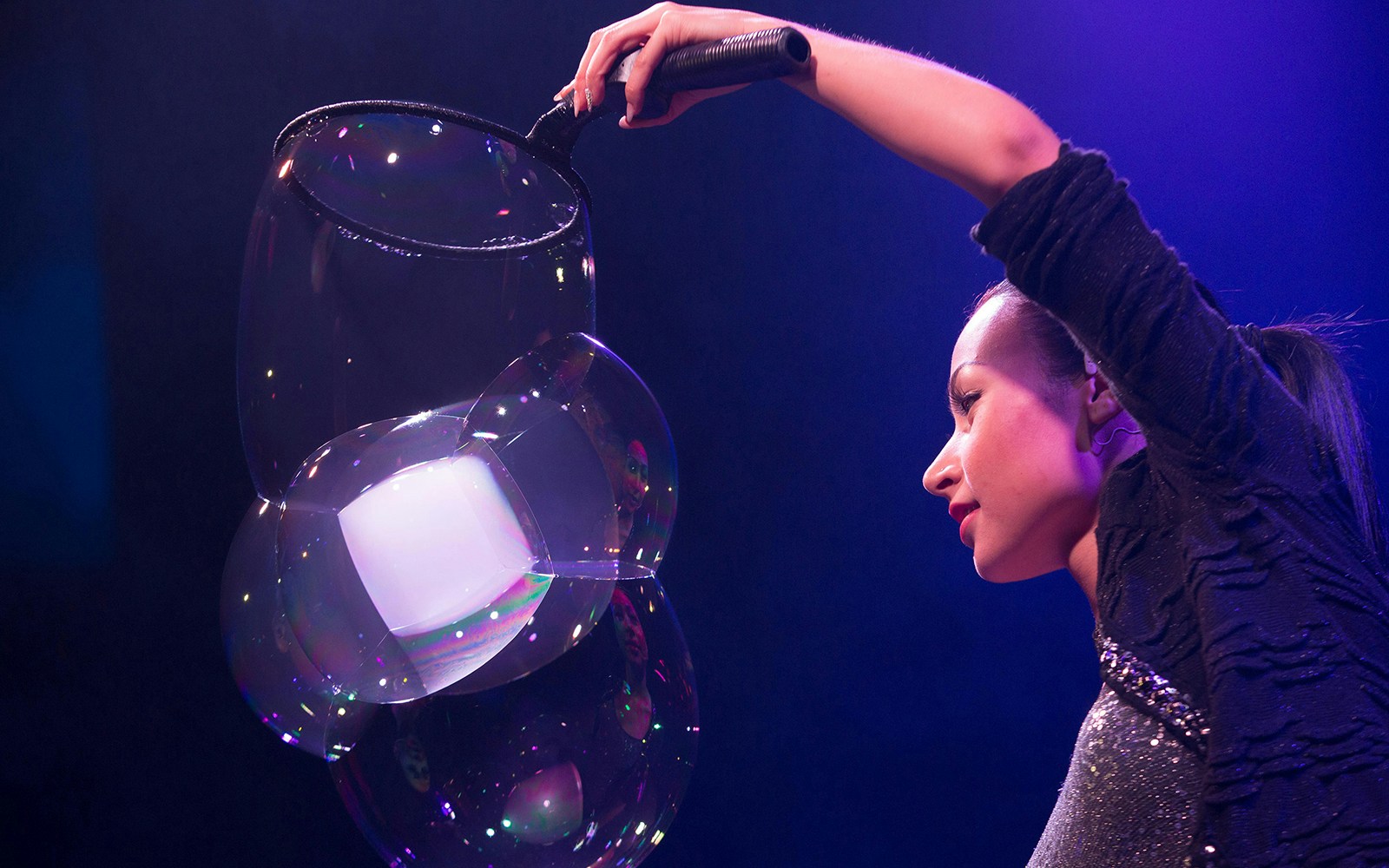 Performer creating large bubbles at The Gazillion Bubble Show.