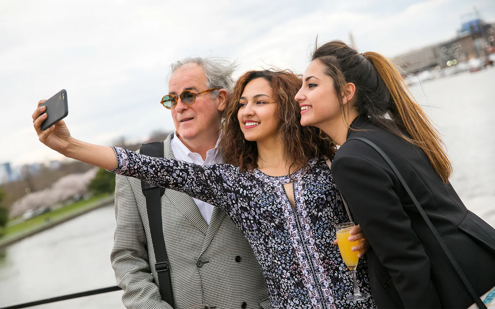 Guests taking a selfie on the deck of the Signature Bottomless Mimosa Brunch Cruise in Washington DC.