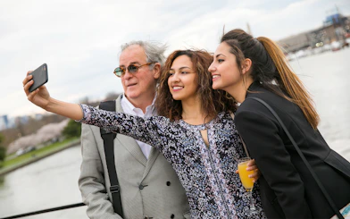 Guests taking a selfie on the deck of the Signature Bottomless Mimosa Brunch Cruise in Washington DC.