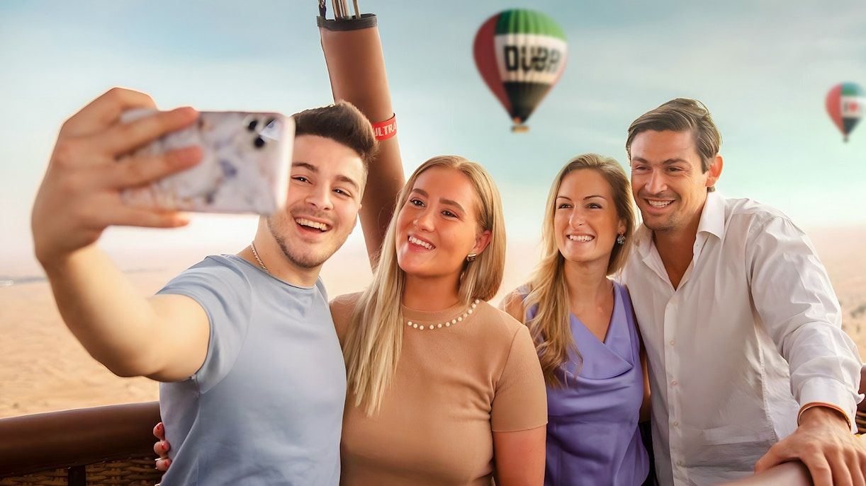 Hot air balloon over Dubai desert at sunrise, part of premium overnight stay and heritage safari.