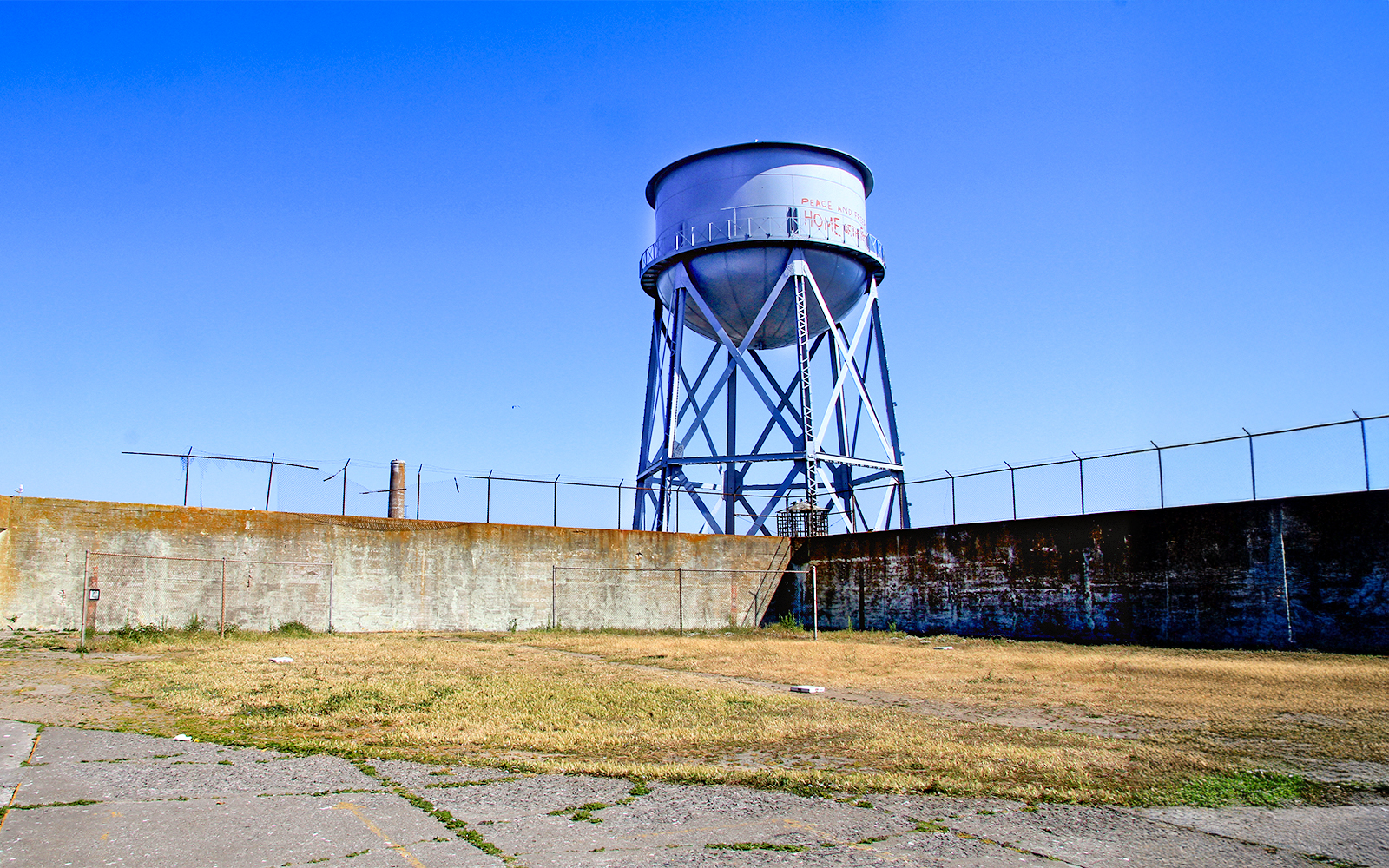 Water tower at Alcatraz Island, San Francisco, with blue sky background.