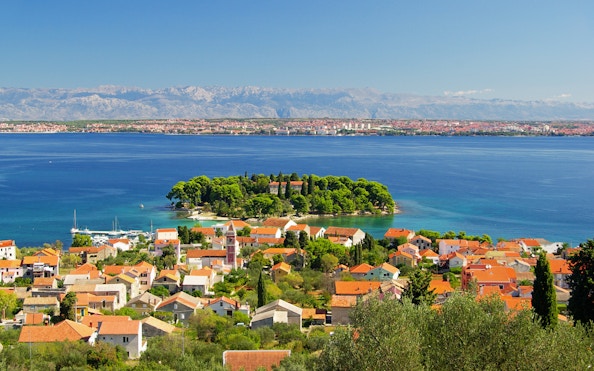Preko Village on Ugljan Island with Adriatic Sea and distant mountains.