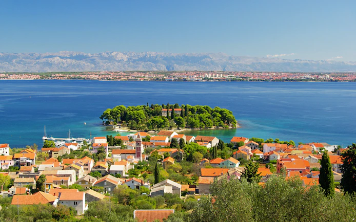 Preko Village on Ugljan Island with Adriatic Sea and distant mountains.
