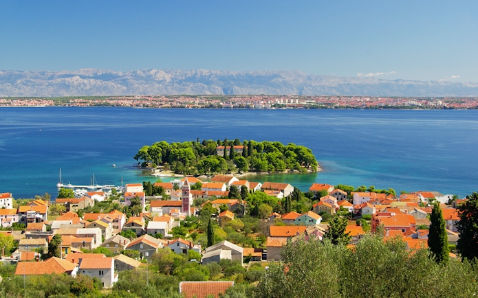 Preko Village on Ugljan Island with Adriatic Sea and distant mountains.