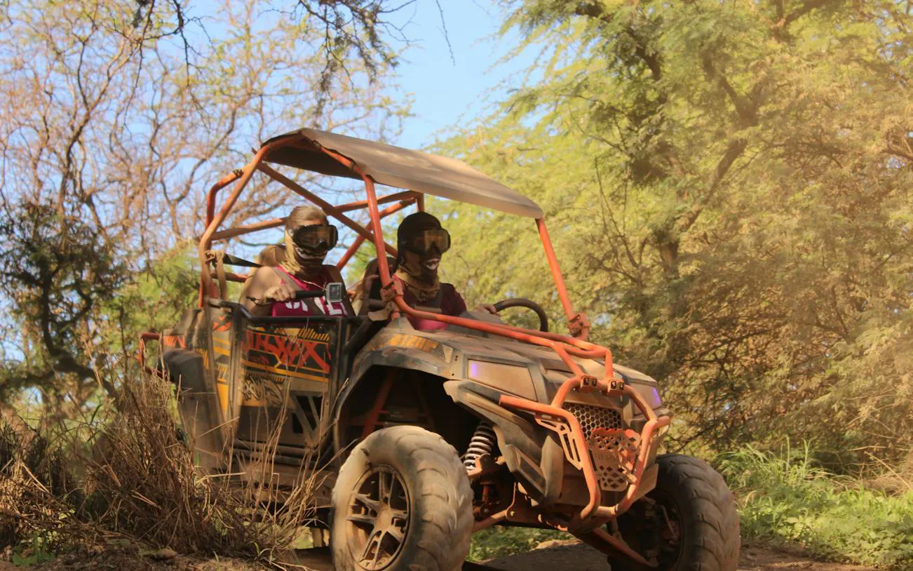 Off-road ATV ride through forested trail in Oahu, part of adventure package.