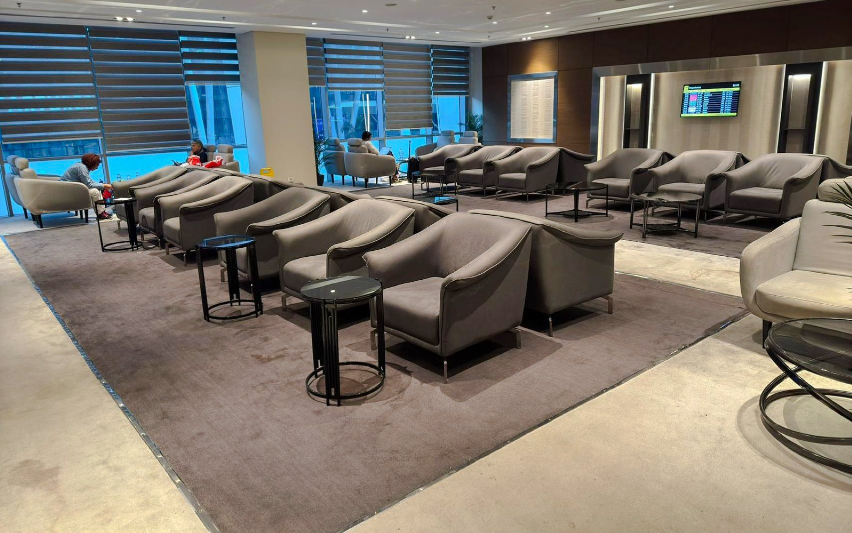 Sofa and chairs in Plaza Premium Lounge, Cairo airport seating area.