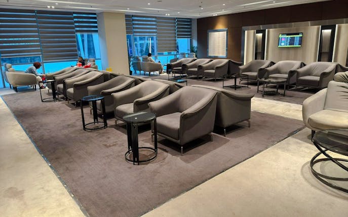 Sofa and chairs in Plaza Premium Lounge, Cairo airport seating area.