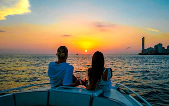 Couple enjoying sunset on a boat in Cartagena Bay.