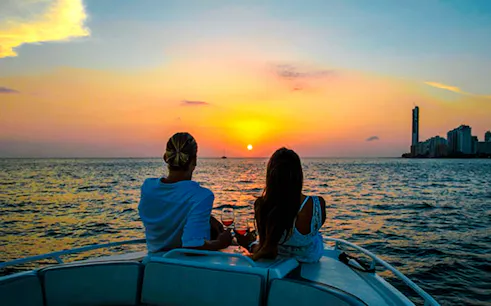 Couple enjoying sunset on a boat in Cartagena Bay.