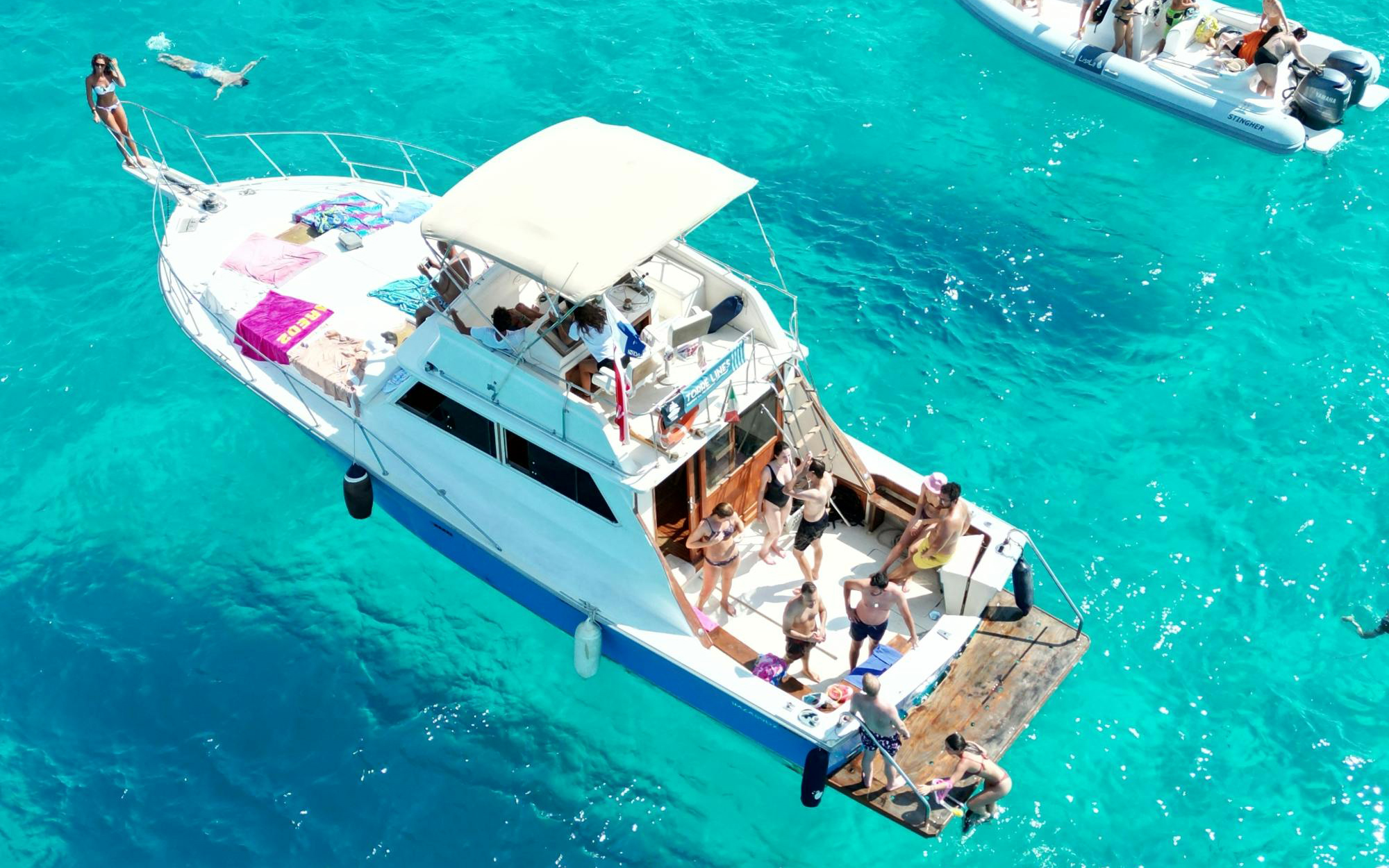 Yacht with people enjoying the sea near Favignana and Levanzo Islands, Trapani.