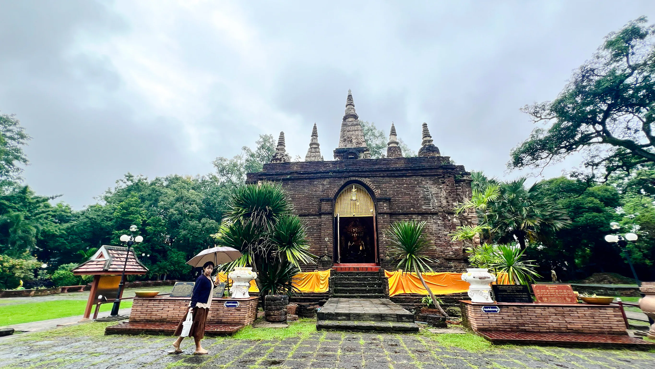 Ancient temple with spires in Chiang Mai surrounded by greenery, part of the Hidden Gems tour.