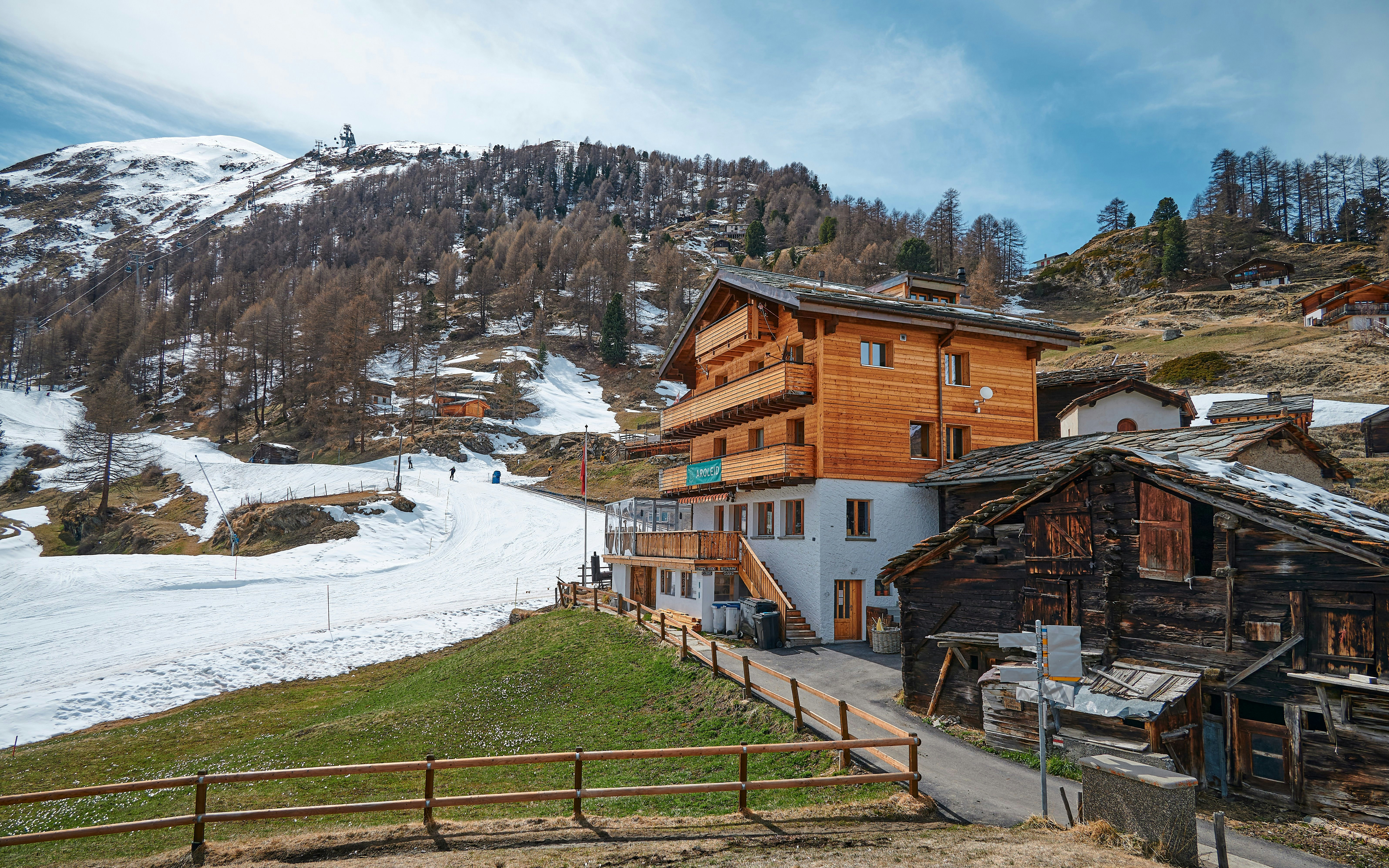Furi Village landscape with wooden chalets and snowy mountains in Zermatt, Switzerland.