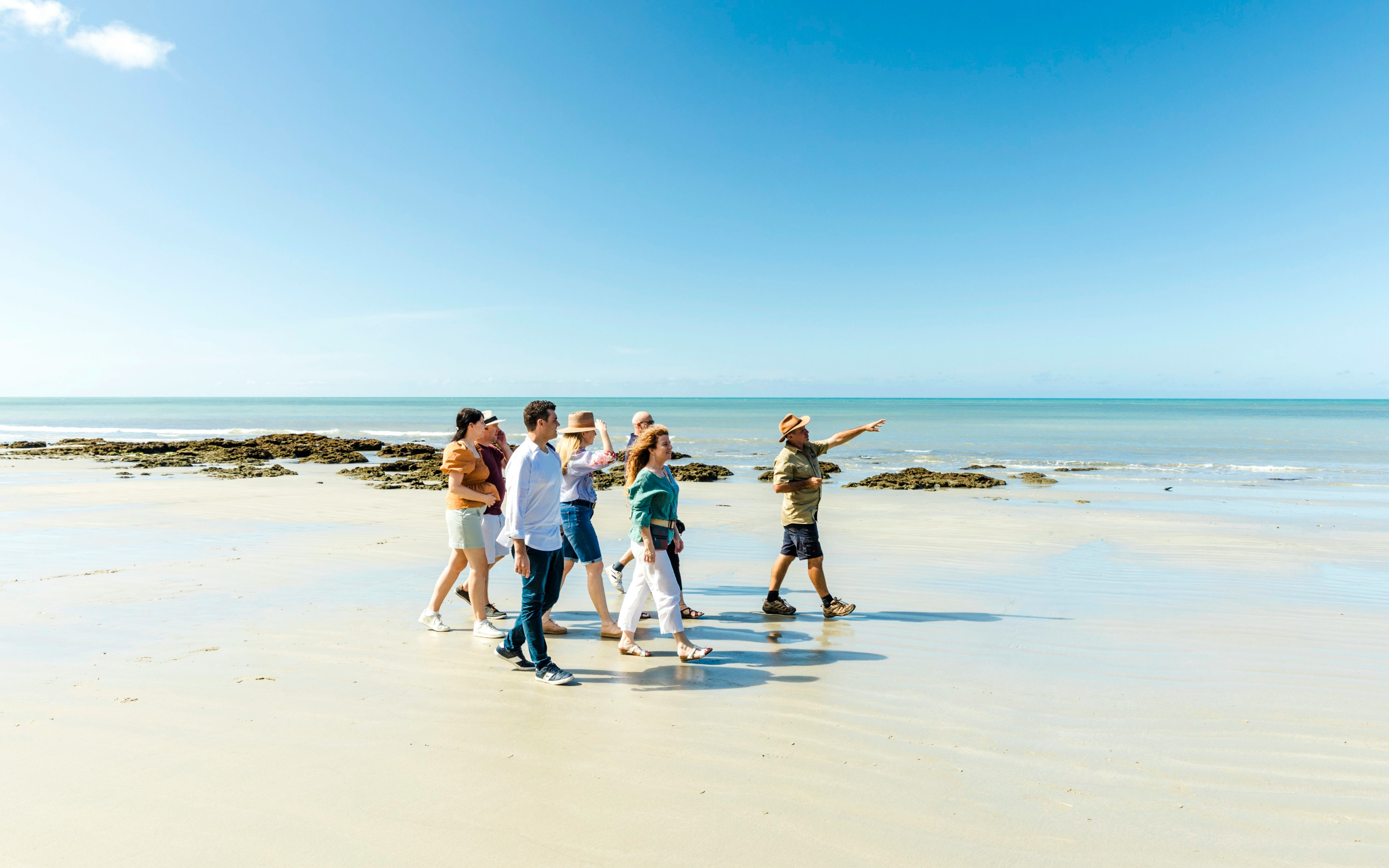 Group walking on Cape Tribulation beach with guide, Billy Tea Safaris tour.