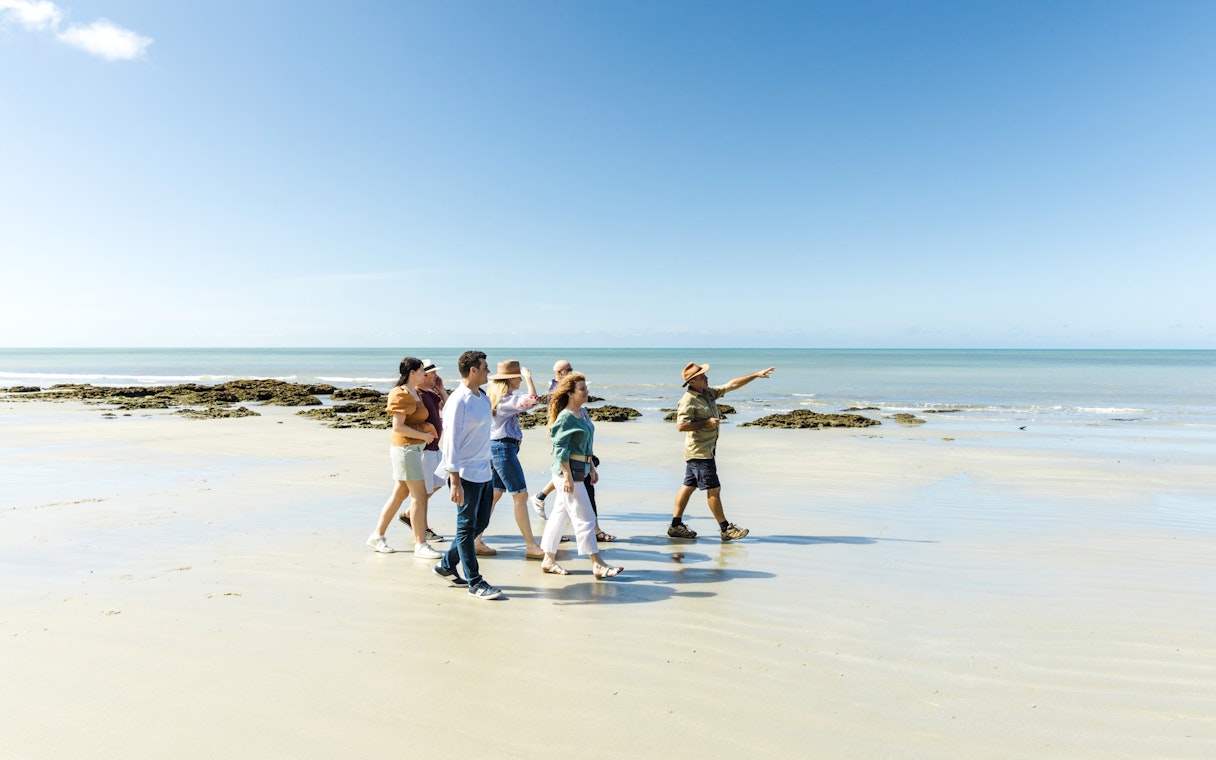 Group walking on Cape Tribulation beach with guide, Billy Tea Safaris tour.