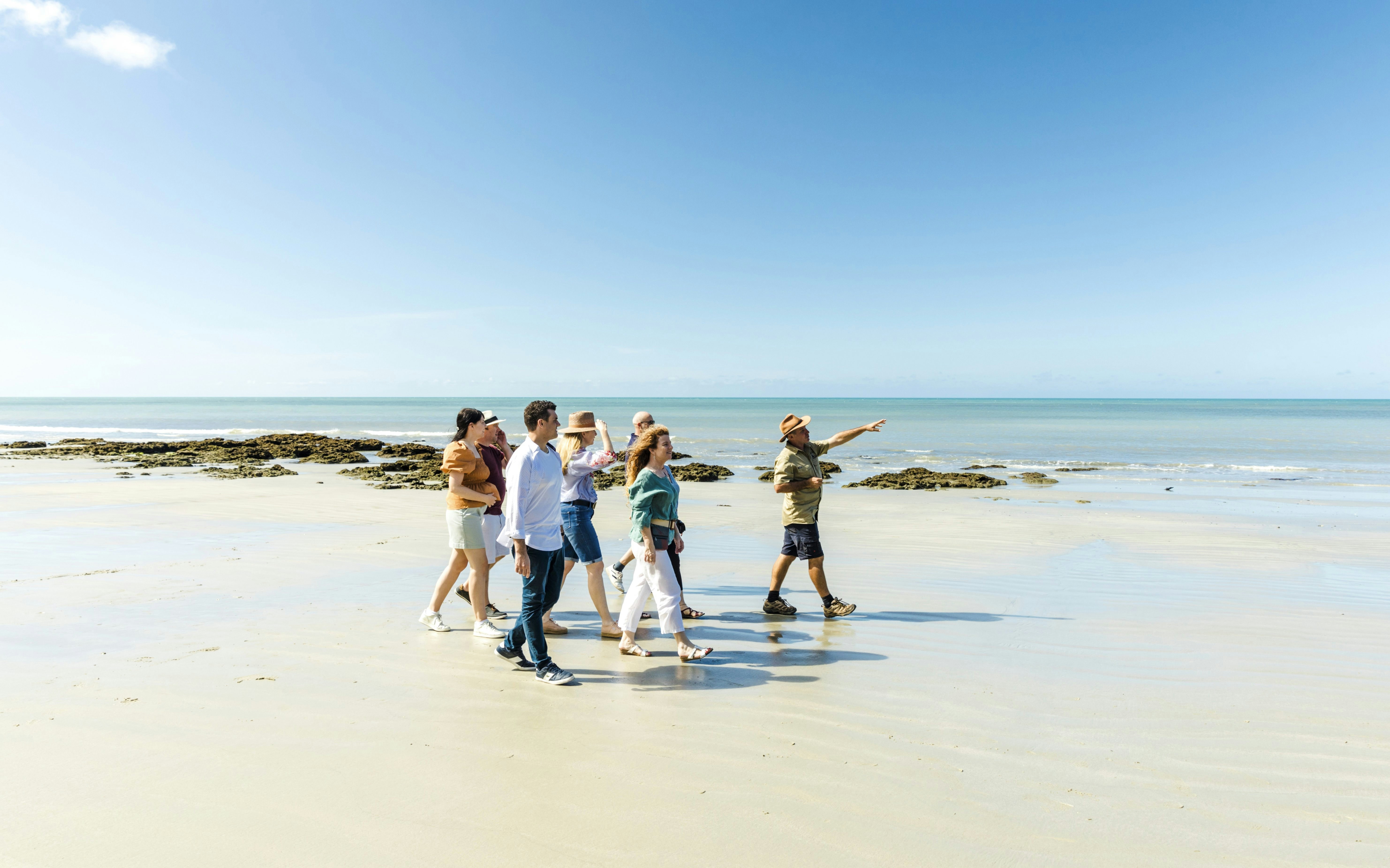 Group walking on Cape Tribulation beach with guide, Billy Tea Safaris tour.