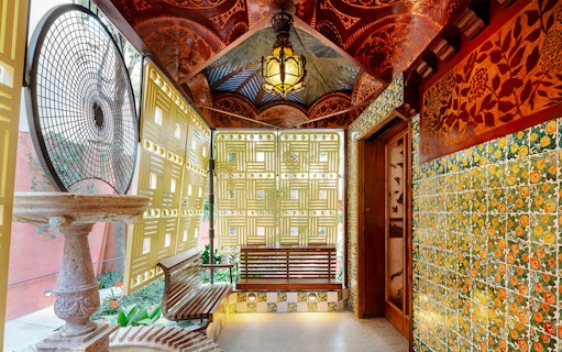 Casa Vicens interior with decorative tiles, lattice windows, and ornate ceiling in Barcelona.