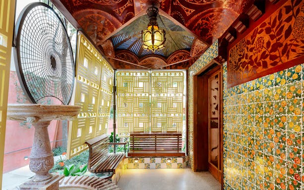 Casa Vicens interior with decorative tiles, lattice windows, and ornate ceiling in Barcelona.