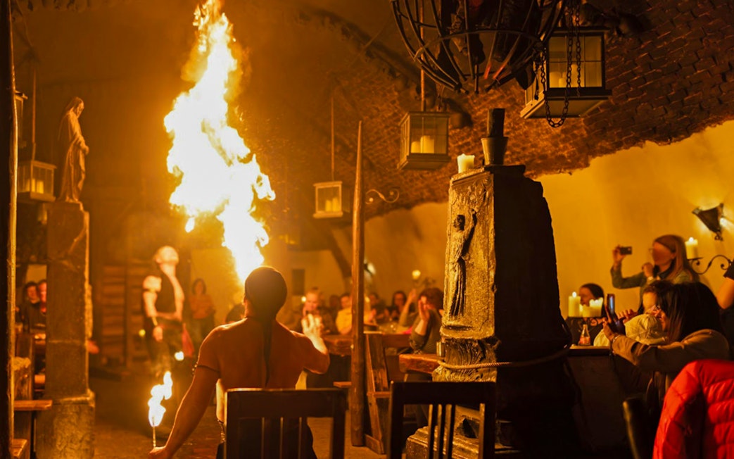 Medieval fire performer entertaining guests at Dětenice Brewery near Prague.