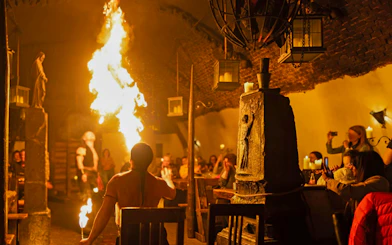 Medieval fire performer entertaining guests at Dětenice Brewery near Prague.
