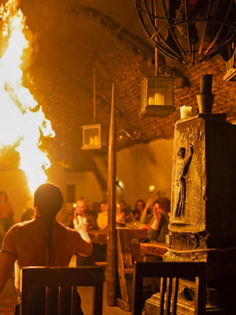 Medieval fire performer entertaining guests at Dětenice Brewery near Prague.