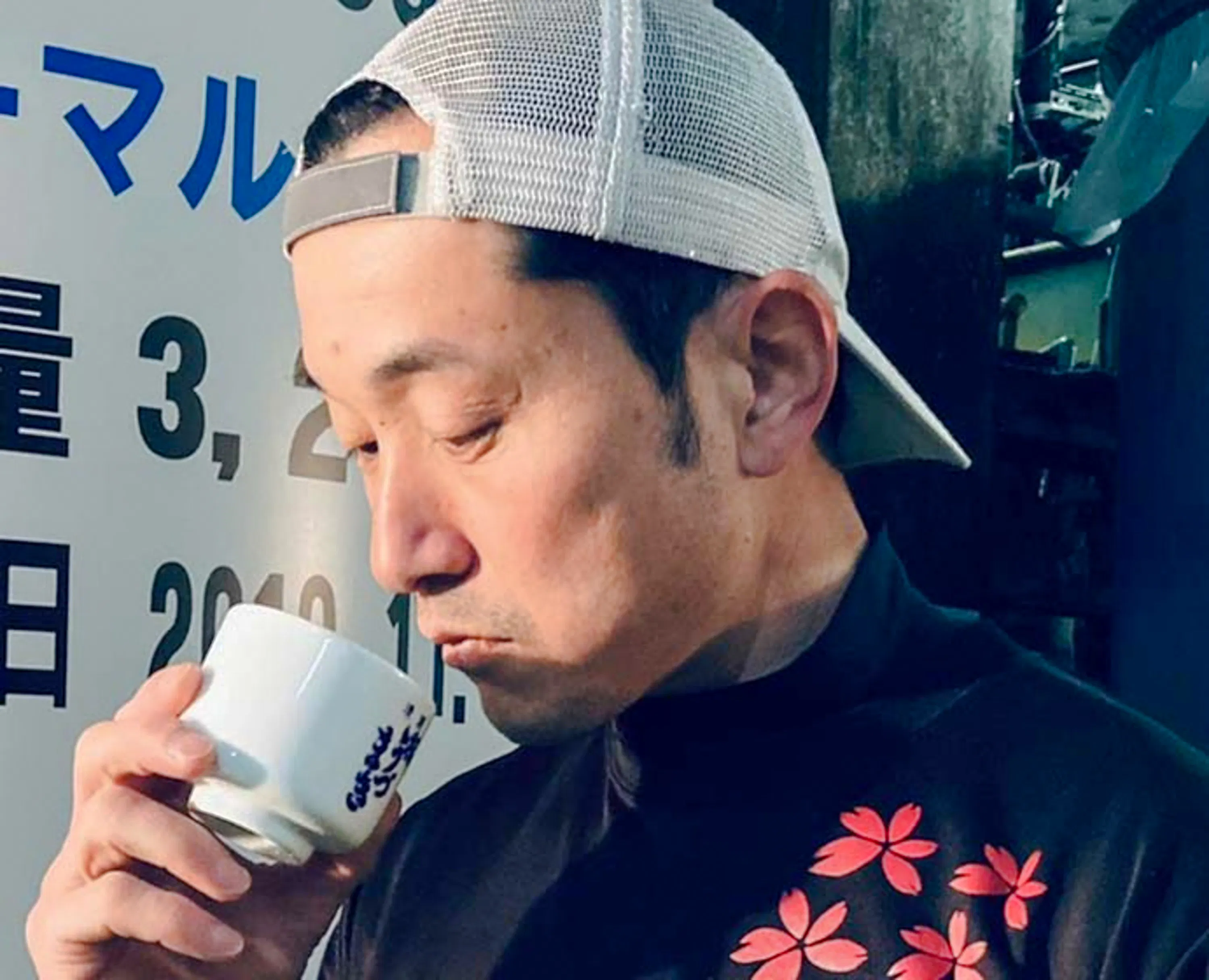 Man tasting sake at Sakura Uzumaki Brewery, Matsuyama, Ehime.