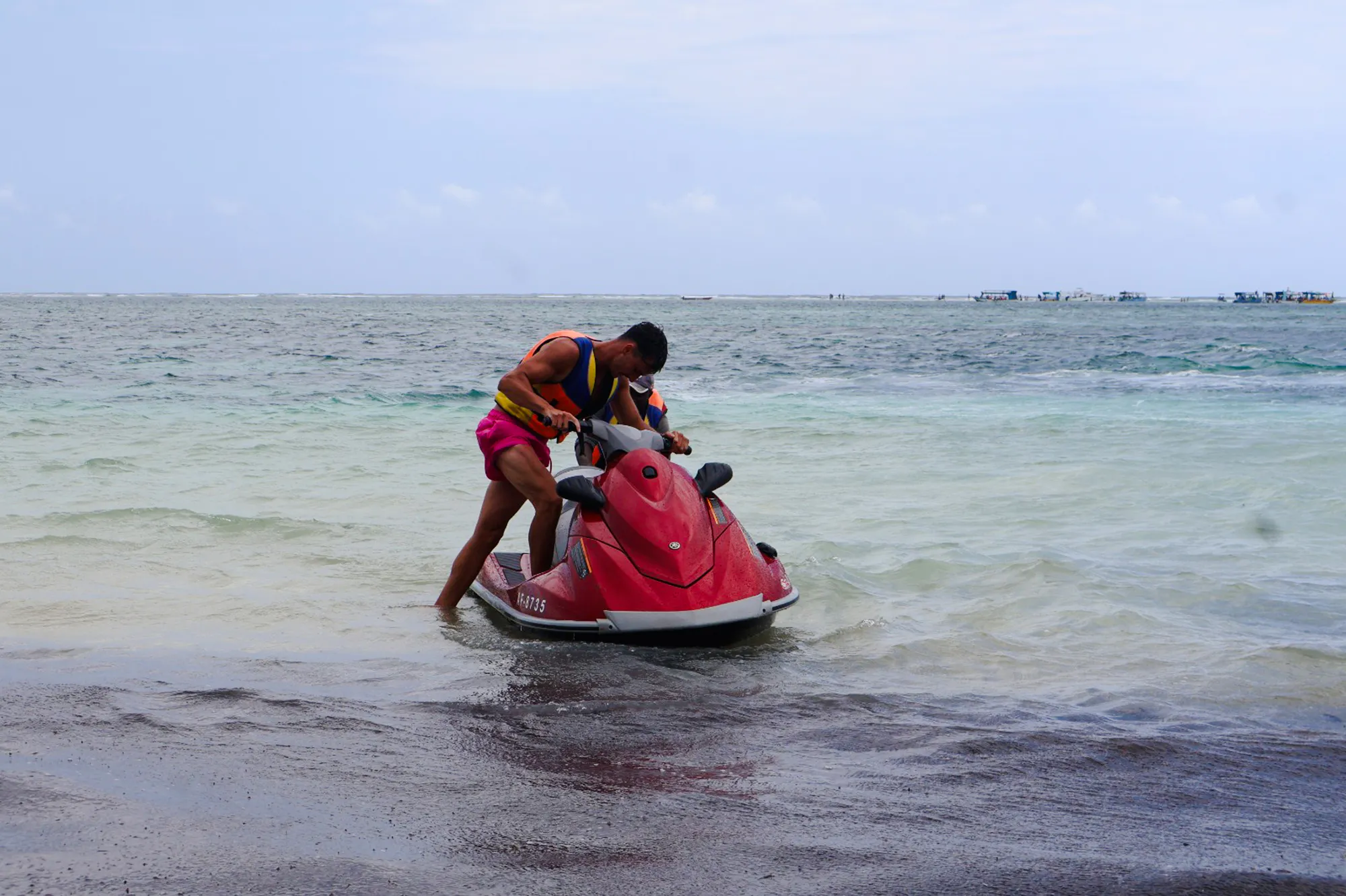 Person preparing for a jet-ski ride at Diani Beach, Kenya.