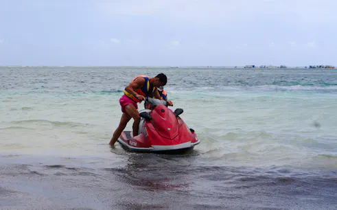 Person preparing for a jet-ski ride at Diani Beach, Kenya.