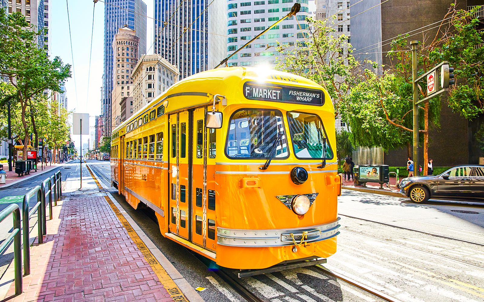 Streetcar on Market Street in San Francisco with city buildings in the background.