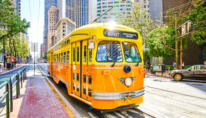 Streetcar on Market Street in San Francisco with city buildings in the background.