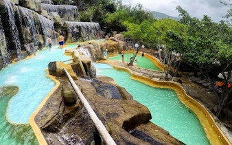 Water park with cascading pools and rock formations, Cai River View, Dubai.