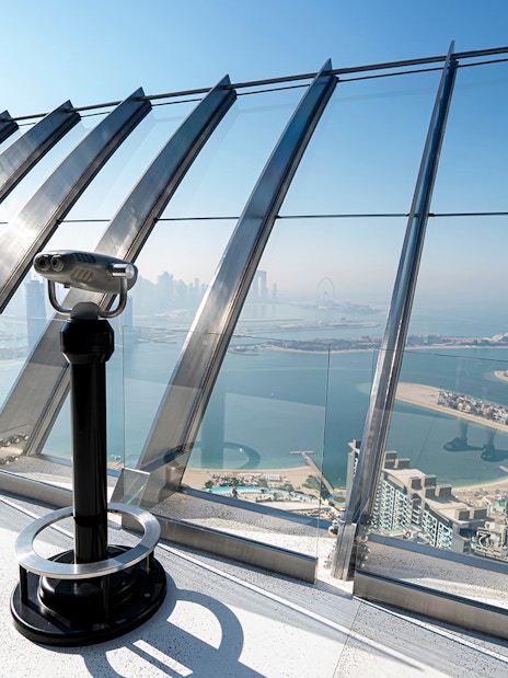 Telescope on observation deck overlooking Palm Jumeirah from Palm Tower, Dubai.