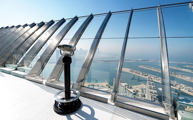 Telescope on observation deck overlooking Palm Jumeirah from Palm Tower, Dubai.