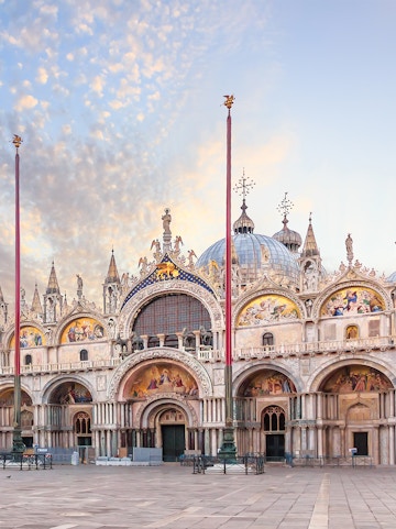 St. Mark's Basilica facade in Venice with ornate architecture and detailed mosaics.