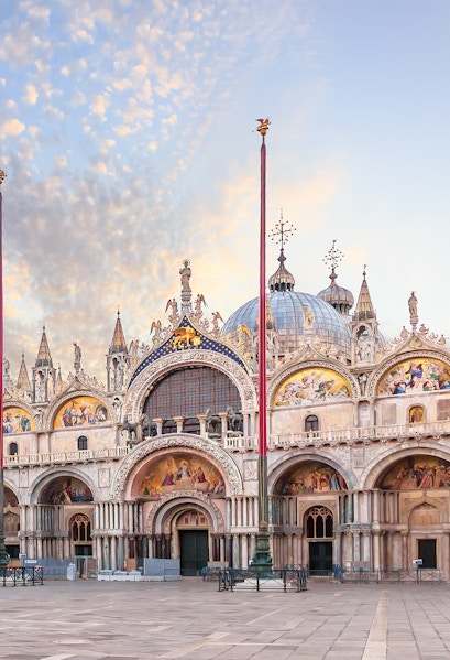 St. Mark's Basilica facade in Venice with ornate architecture and detailed mosaics.